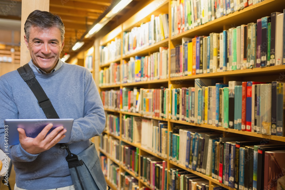 Man smiling while holding tablet pc Man smiling while holding tablet pc