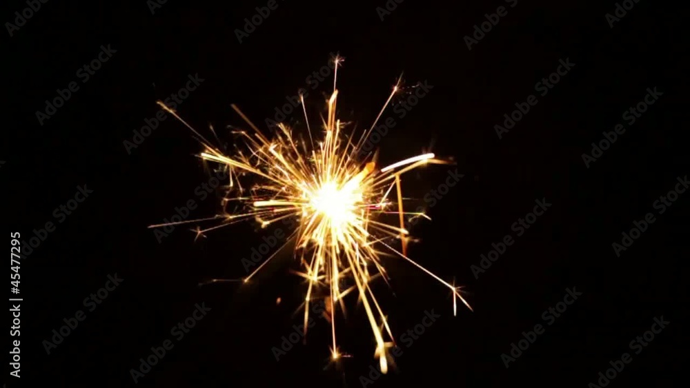 Bengal light burning with bright sparkles on dark background Bengal light burning with bright sparkles on dark background