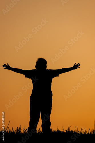 Person greeting sunset or sunrise