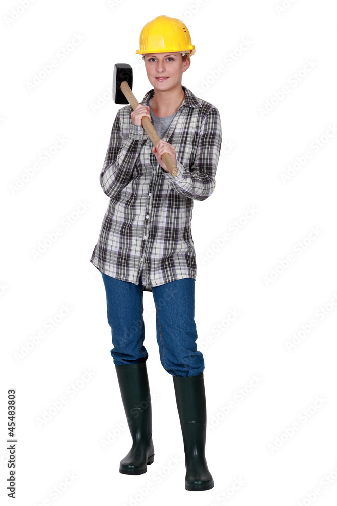 Attractive woman stood with sledge hammer Attractive woman stood with sledge hammer