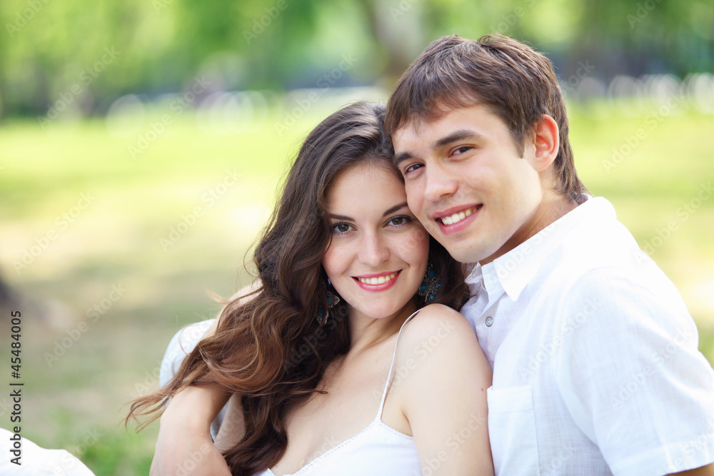 Young love Couple smiling under blue sky Young love Couple smiling under blue sky