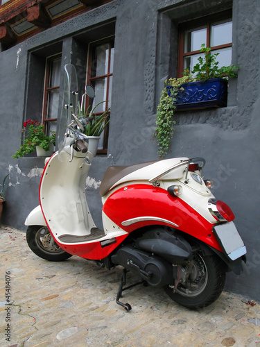 Trendy moped against old building. Fribourg, Switzerland