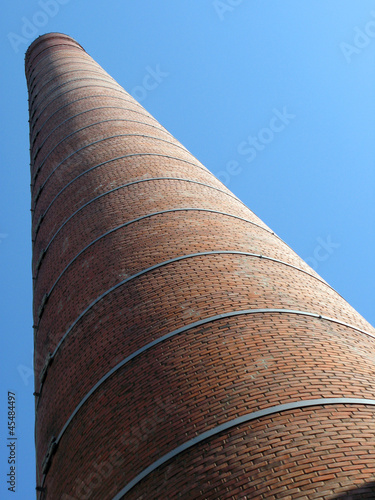 Brick pipe against blue sky photo