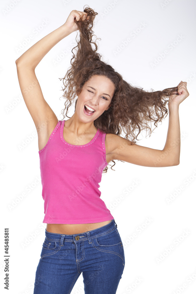 young beautiful woman pulling her hair and smiling young beautiful woman pulling her hair and smiling
