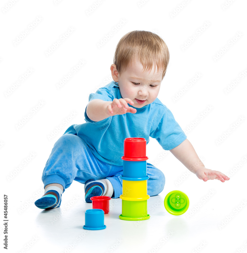 baby playing with colourful cup toys on floor, isolated over whi baby playing with colourful cup toys on floor, isolated over whi