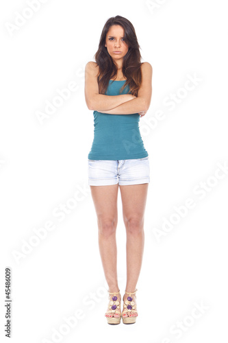 young woman looking angry and upset with arms crossed