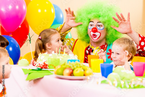happy kids with clown on birthday party