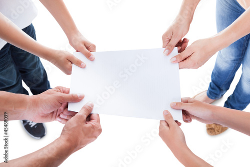 Elevated View Of Family Holding Blank Paper