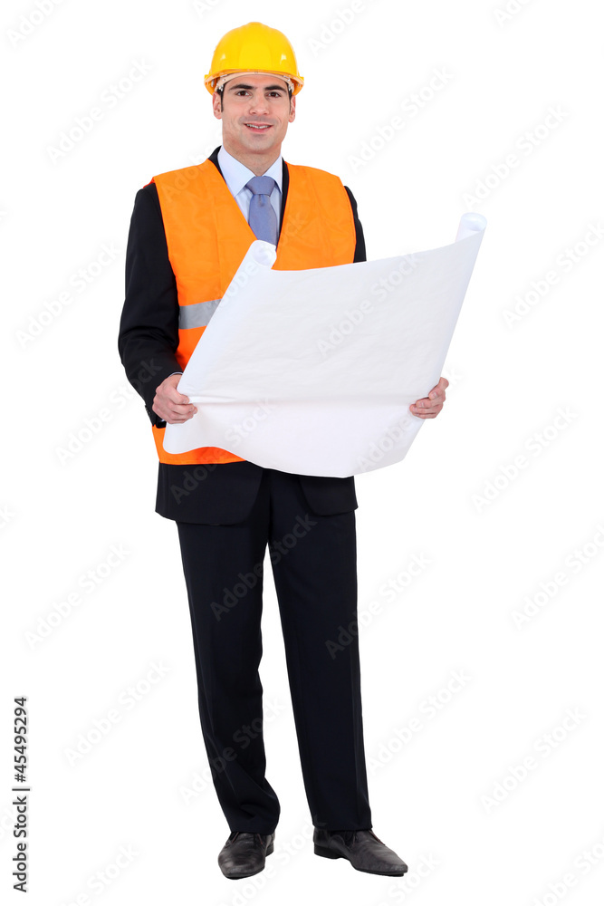 Confident entrepreneur looking at blueprints Confident entrepreneur looking at blueprints