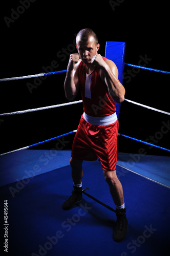 Male boxer in ring doing exercise