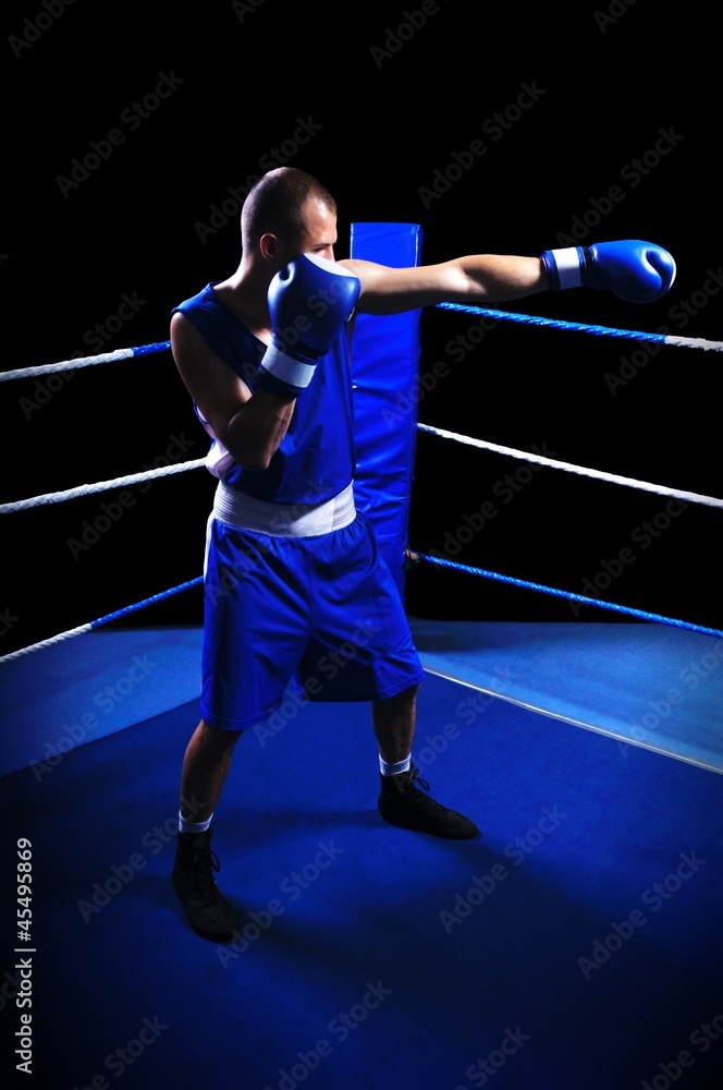 Male boxer in ring doing exercise Male boxer in ring doing exercise