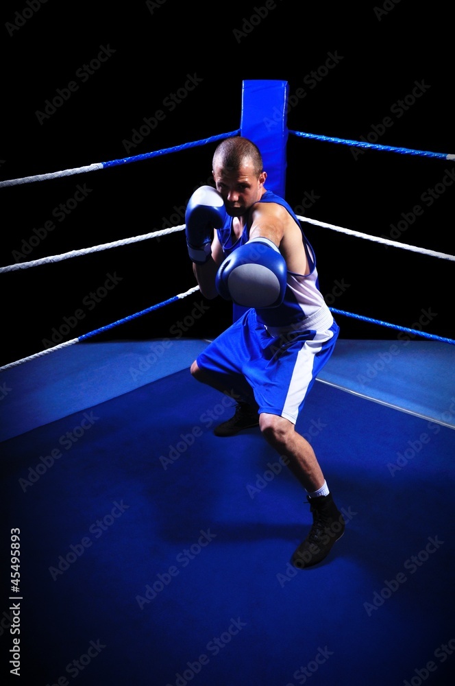 Male boxer in ring doing exercise