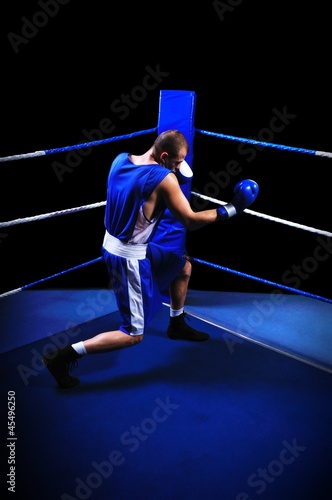 Male boxer in ring doing exercise