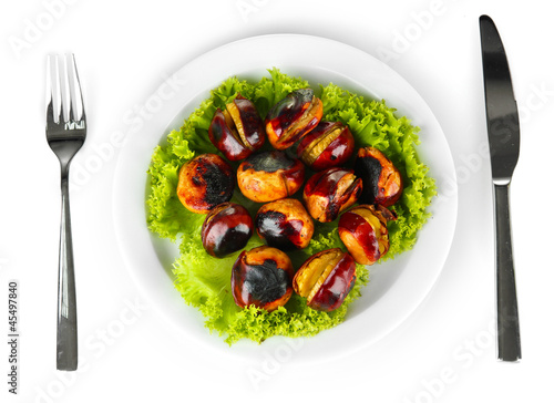 roasted chestnuts with lettuce in the white plate with fork and