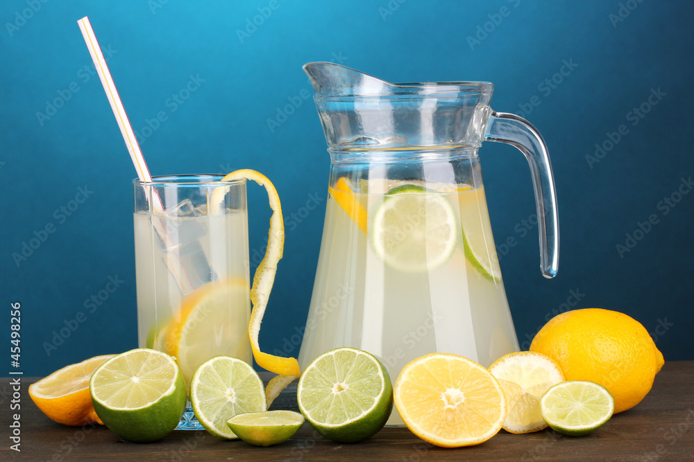 Citrus lemonade in pitcher and glass of citrus around Citrus lemonade in pitcher and glass of citrus around