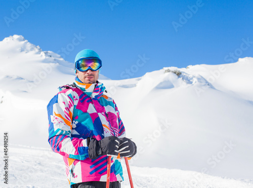 Young man with skis and a ski wear
