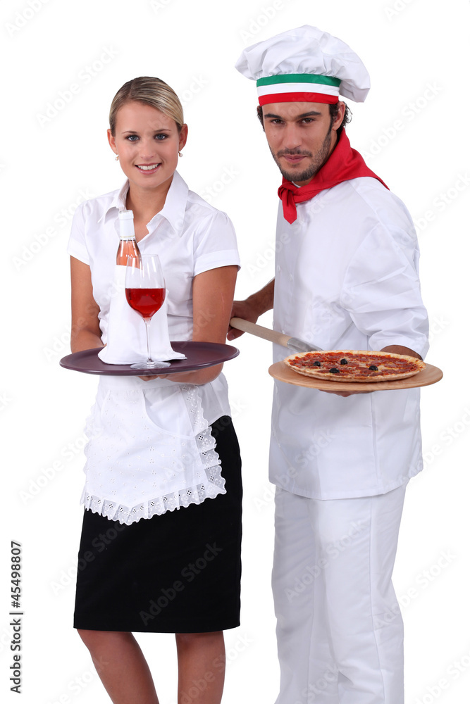 Pizza chef standing next to a wine waitress Pizza chef standing next to a wine waitress