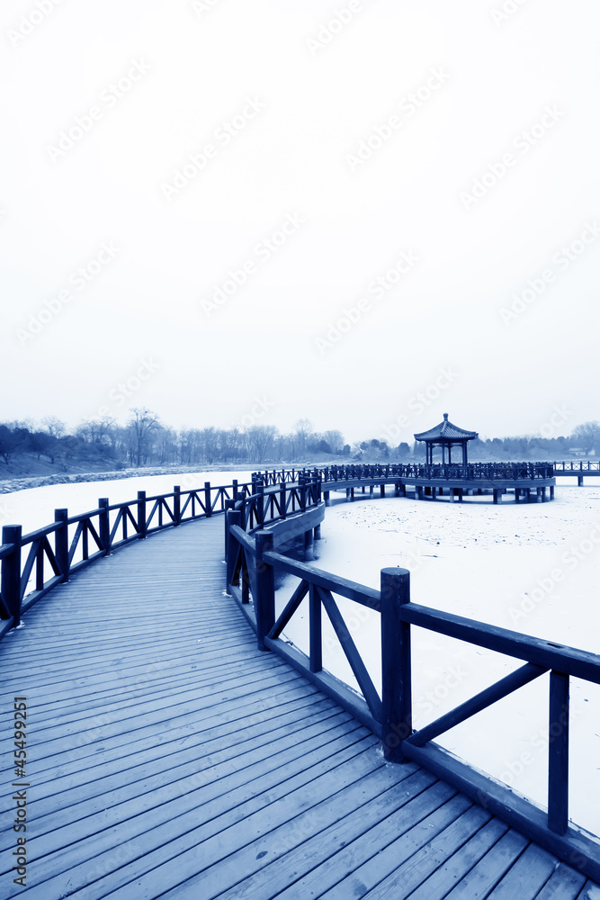 Chinese traditional style wooden bridge in the snow