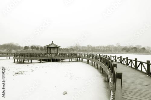 Chinese traditional style wooden bridge in the snow © zhang yongxin
