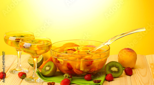 punch in bowl and glasses with fruits,