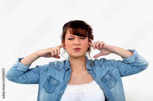 Woman blocking her ears