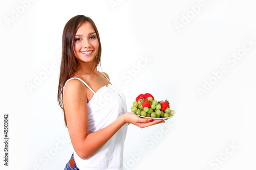 Young woman with fruits and vegetables on a dish © majesticca