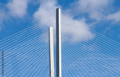Modern bridge pylons on a blue sky.
