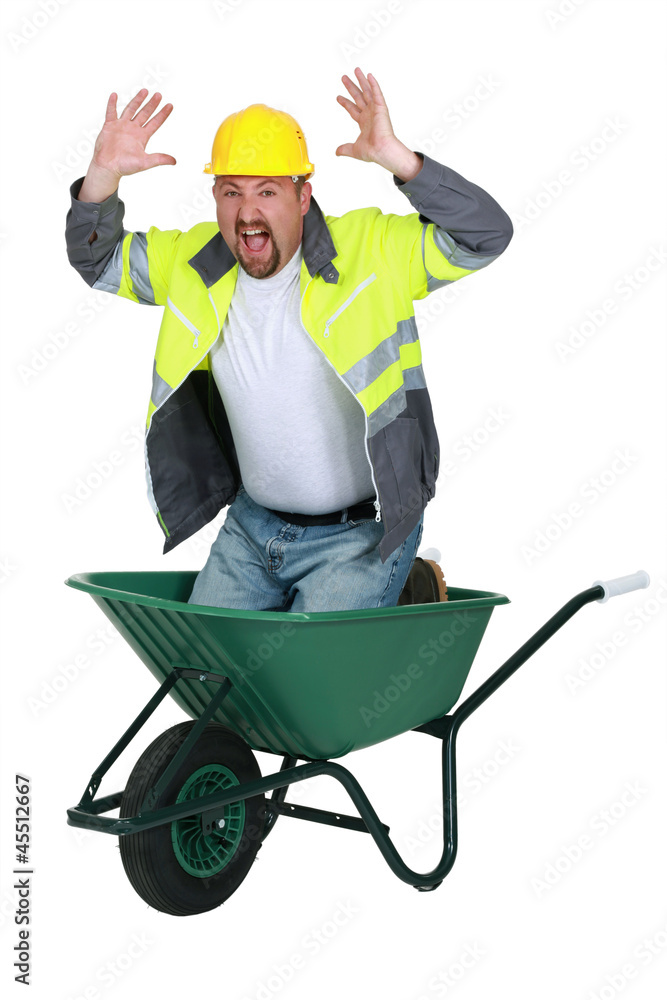 Laborer sitting in a wheelbarrow screaming Laborer sitting in a wheelbarrow screaming