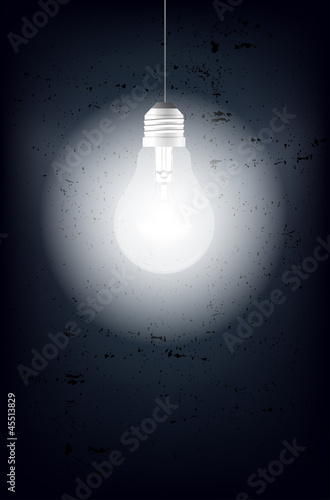 Shining light bulb and grungy background - place for text