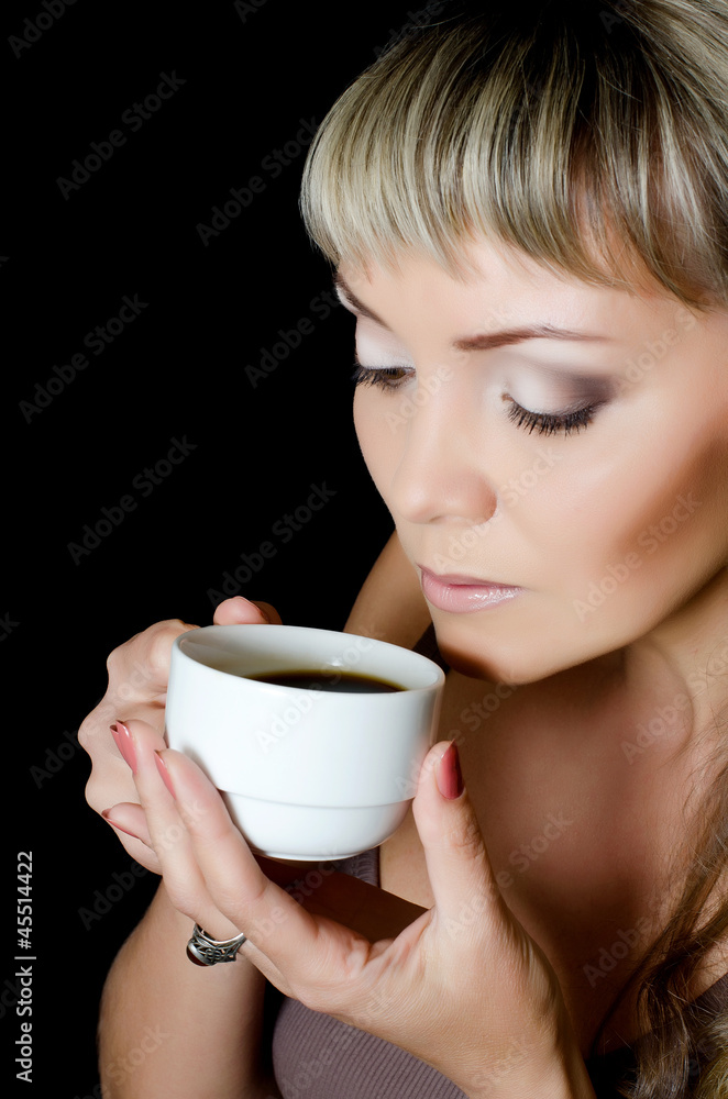 The beautiful elegant woman with a coffee cup The beautiful elegant woman with a coffee cup