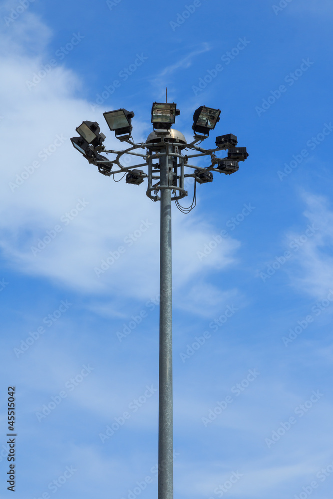Stadium light pole on blue sky background