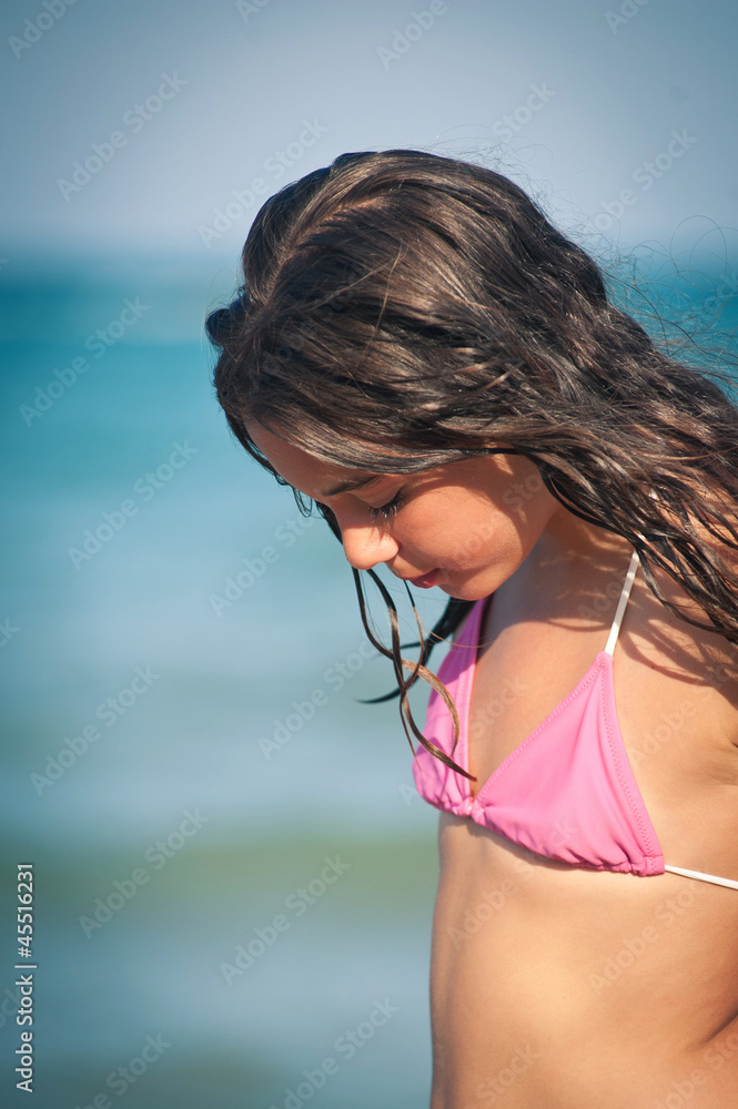 Intimate portrait of young girl on the beach. Shallow depth of f Intimate portrait of young girl on the beach. Shallow depth of f