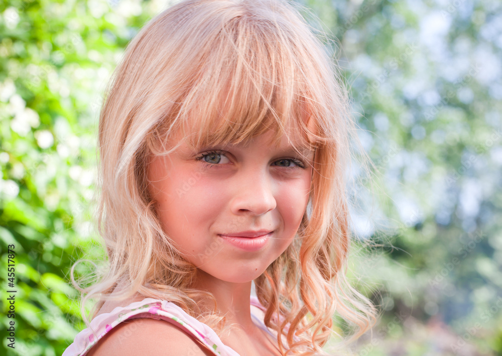 Beautiful slightly smiling little blond girl outdoor portrait Beautiful slightly smiling little blond girl outdoor portrait