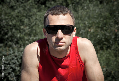 Portrait of young man in black  sunglasses
