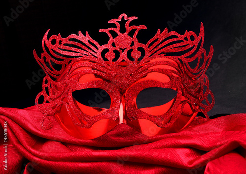 Paper mask on a red velvet.