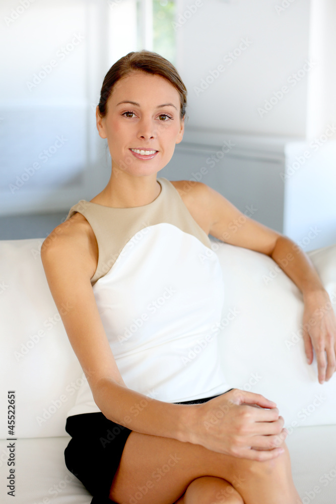 Portrait of attractive woman sitting in couch Portrait of attractive woman sitting in couch