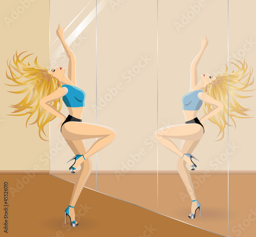 Beautiful blonde woman dancing  in front of the mirrow in gym cl