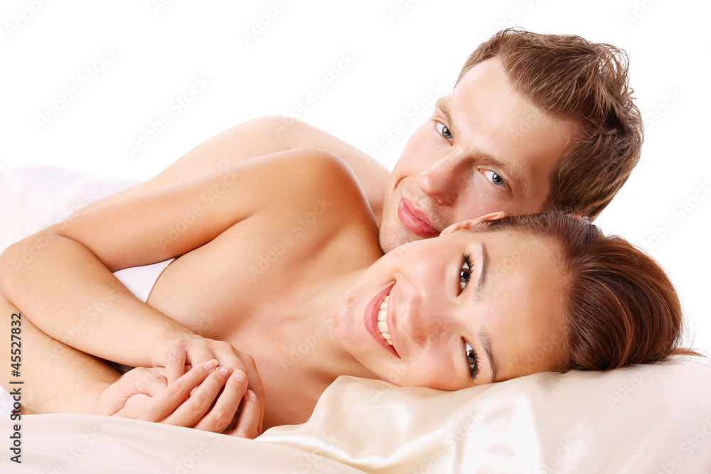 A loving affectionate nude heterosexual couple on the bed A loving affectionate nude heterosexual couple on the bed