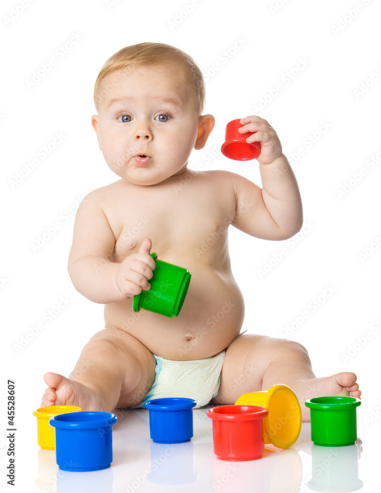 Baby playing with cup toys. Isolated on white background Baby playing with cup toys. Isolated on white background