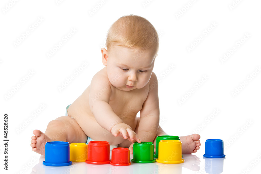 Baby playing with cup toys. Isolated on white background Baby playing with cup toys. Isolated on white background
