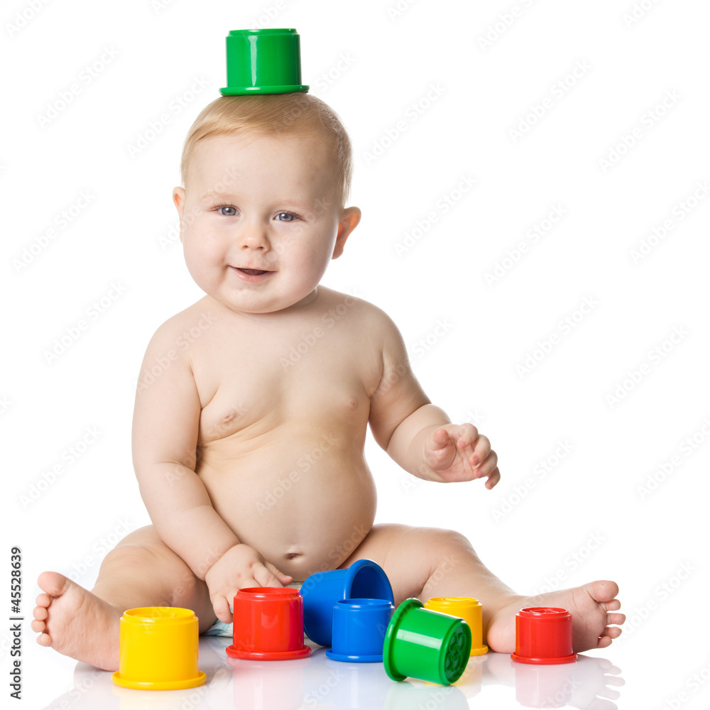 Baby playing with cup toys. Isolated on white background Baby playing with cup toys. Isolated on white background
