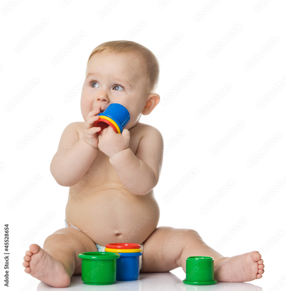 Baby playing with cup toys. Isolated on white background Baby playing with cup toys. Isolated on white background