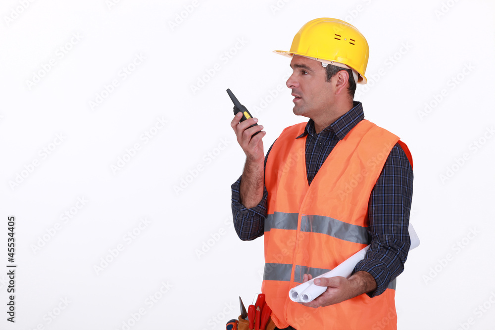 Labourer speaking into a walkie-talkie