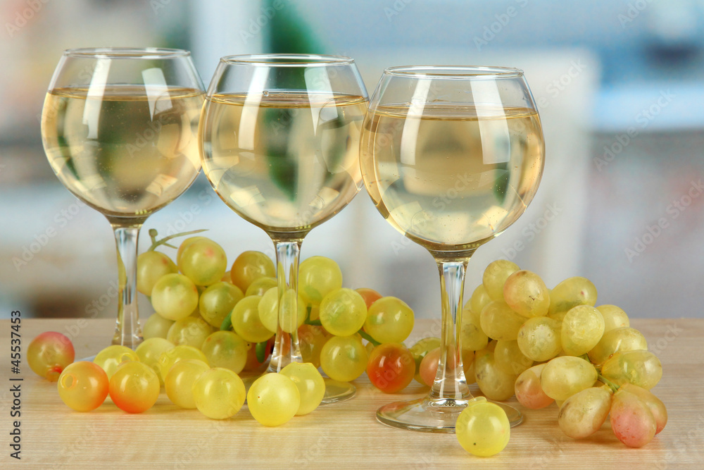 White wine in glass on room background White wine in glass on room background