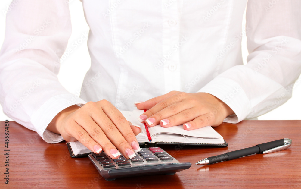 Woman's hands counts on the calculator, close-up Woman's hands counts on the calculator, close-up