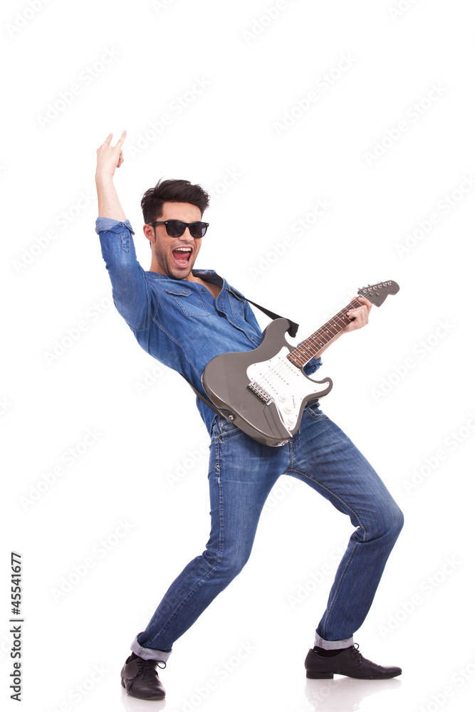 young man performing on guitar young man performing on guitar