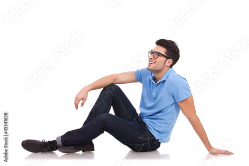 young man on the floor looking away