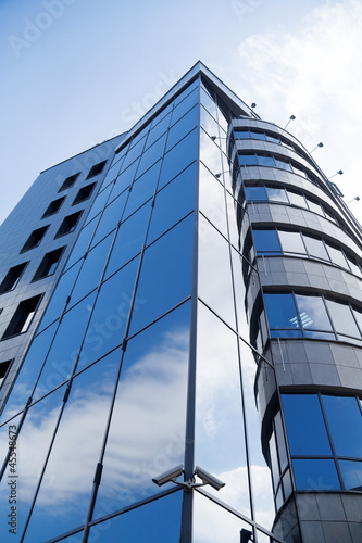 skyscraper window with bright blue sky reflected