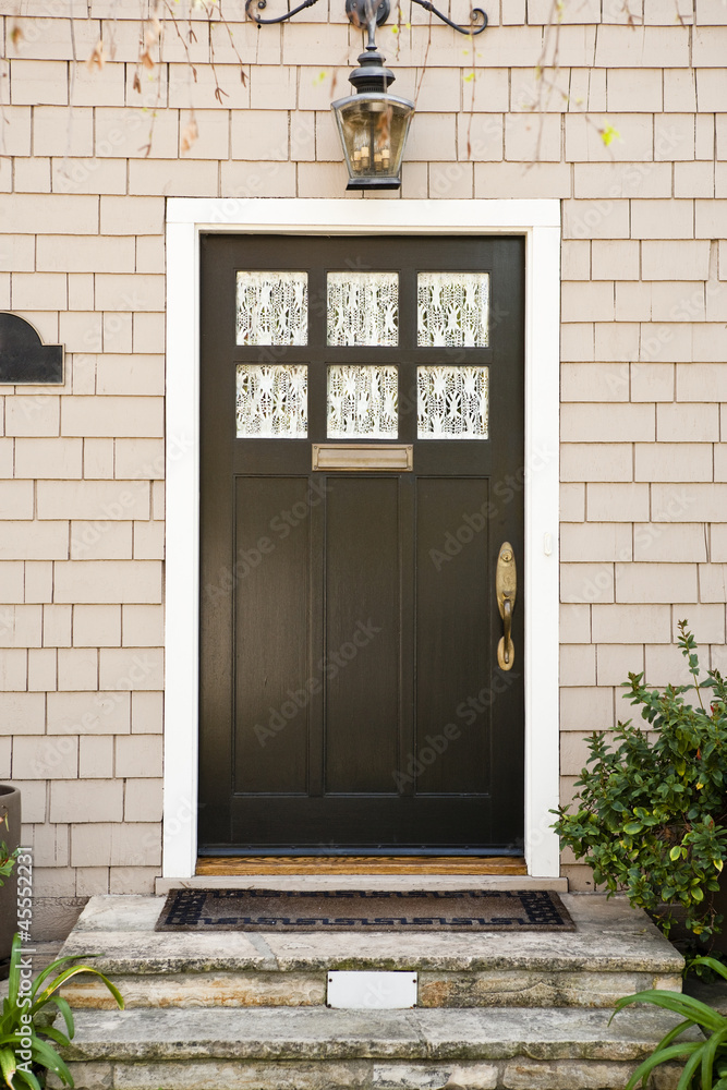 Front door with an overhead light and view of the front steps