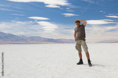 Lonely man on salt desert. Death Valley. USA.